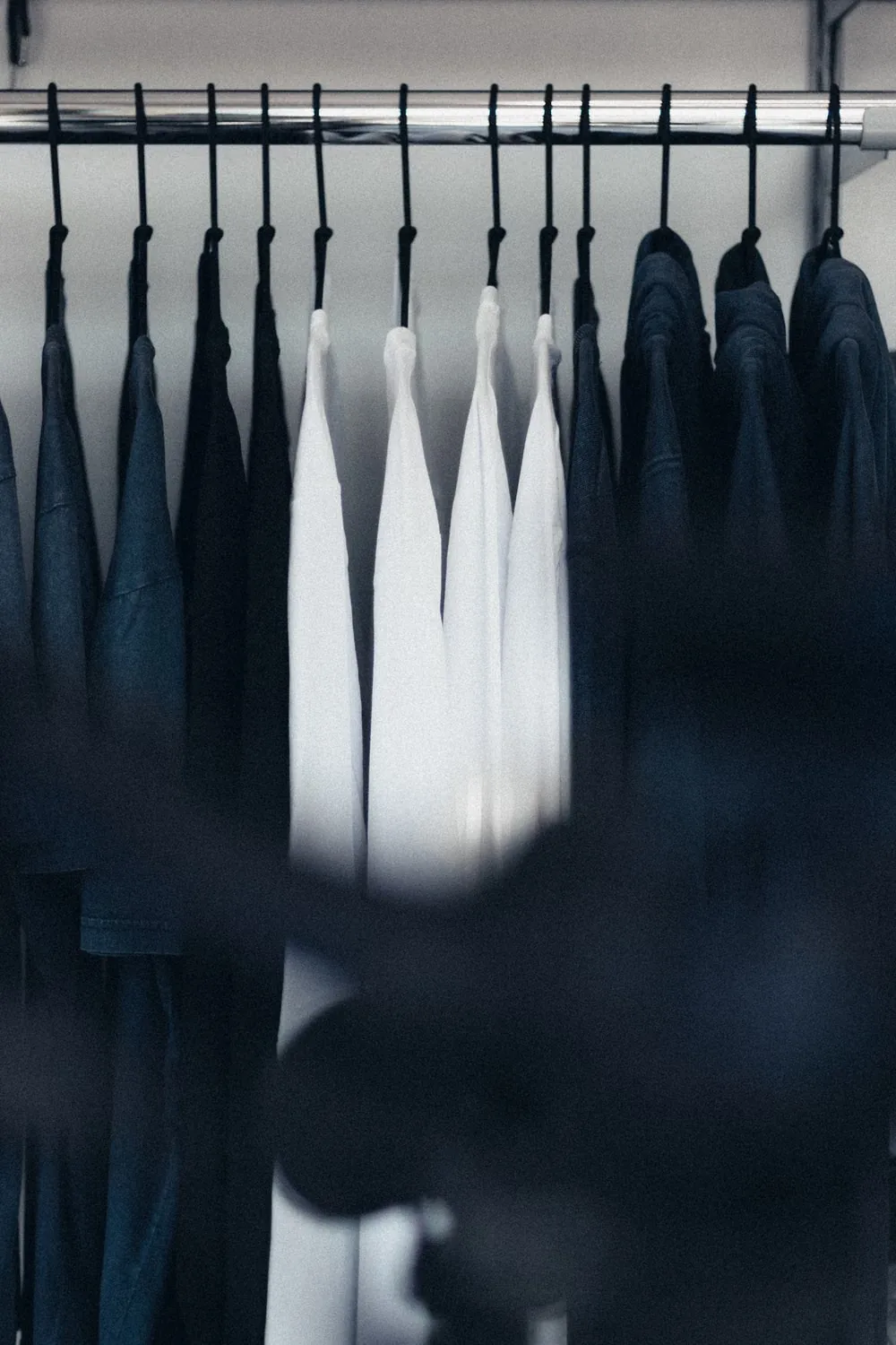 Everyday clothes hanging in a wardrobe